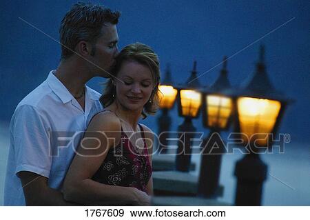 Couple embrace in the evening View Large Photo Image Stock Photo - Couple embrace in the evening. Fotosearch