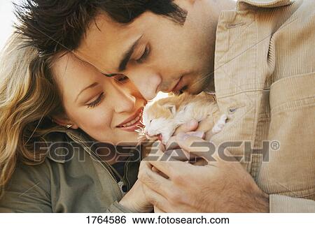 Couple hold kitten View Large Photo Image Stock Photograph - Couple hold kitten. Fotosearch
