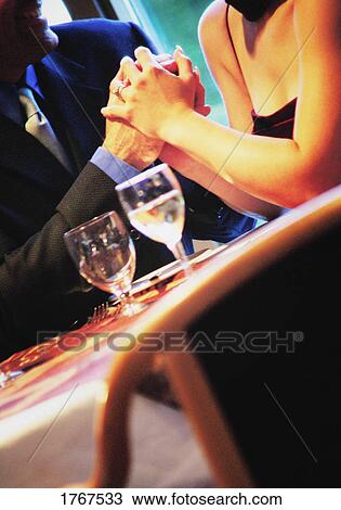 Stock Image - Couple holding hands. Fotosearch