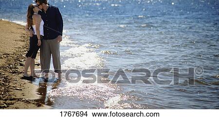 Couple kisses on the beach View Large Photo Image Picture - Couple kisses on the beach. Fotosearch