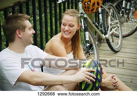 Couple taking a break after bike ride View Large Photo Image Stock Photo - Couple taking a break after bike ride. Fotosearch