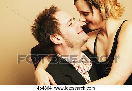 Picture - Man and woman smile and embrace. Fotosearch