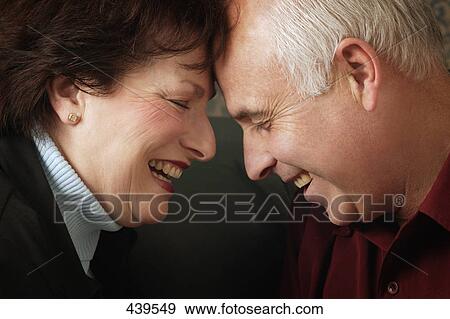 Married couple laugh together View Large Photo Image Stock Photo - Married couple laugh together. Fotosearch