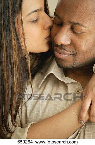 Woman kisses man View Large Photo Image Picture - Woman kisses man. Fotosearch