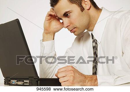 Businessman in front of lap top View Large Photo Image Stock Photo - Businessman in front of lap top. Fotosearch
