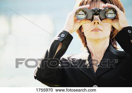 Stock Image - Businesswoman looks into the future. Fotosearch