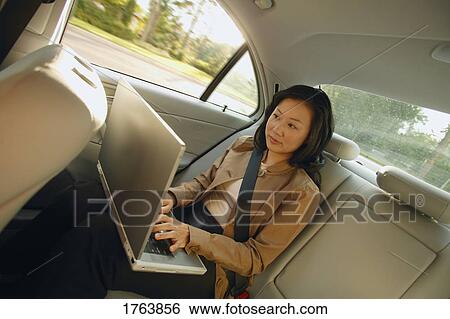 Businesswoman works on laptop View Large Photo Image Stock Photograph - Businesswoman works on laptop. Fotosearch