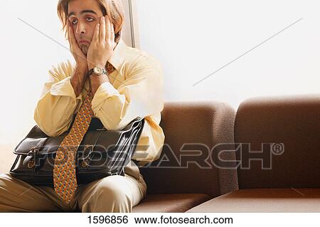 Stock Photograph - Man sits in airport. Fotosearch