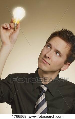 Stock Photo - Man with a light bulb. Fotosearch