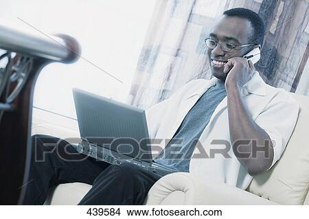 Picture - Man working from home. Fotosearch