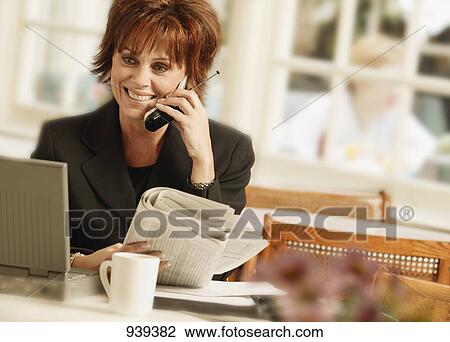 Stock Image - Woman talking on cell phone. Fotosearch