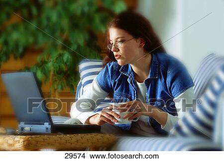 Picture - Woman working on lap top computer. Fotosearch
