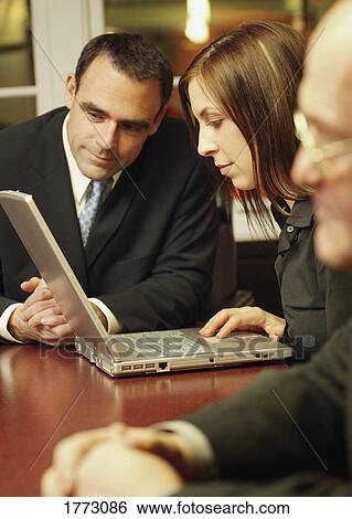 Stock Image - A business meeting. Fotosearch - Search Stock Photography, Poster Photos, Pictures, and Photo Clip Art