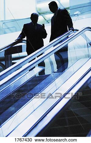 A conversation on an escalator View Large Photo Image Stock Image - A conversation on an escalator. Fotosearch