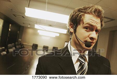 Businessman wearing a headset View Large Photo Image Stock Image - Businessman wearing a headset. Fotosearch