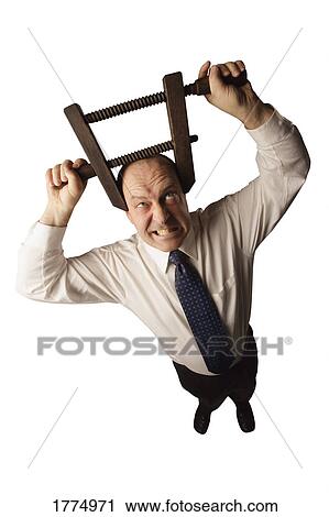 Businessman with head in vice View Large Photo Image Stock Image - Businessman with head in vice. Fotosearch