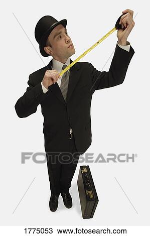 Businessman with tape measure View Large Photo Image Stock Image - Businessman with tape measure. Fotosearch
