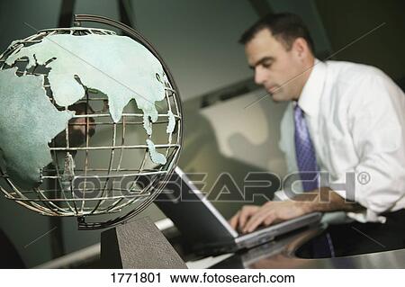 Businessman working on laptop View Large Photo Image Stock Image - Businessman working on laptop. Fotosearch