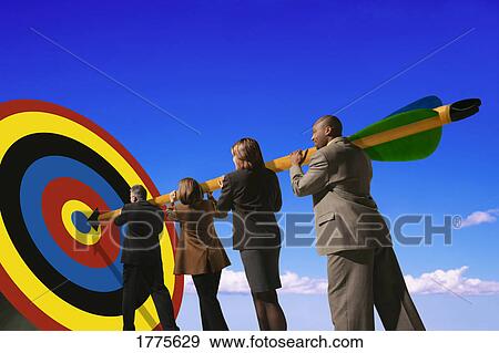 Stock Photo - Businesspeople putting arrow on target. Fotosearch