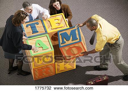 Businesspeople putting together blocks View Large Photo Image Stock Image - Businesspeople putting together blocks. Fotosearch