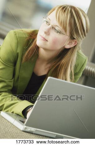 Businesswoman working at laptop View Large Photo Image Stock Image - Businesswoman working at laptop. Fotosearch