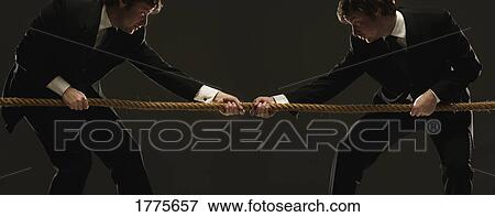 Men pulling against each other in a tug 'o' war View Large Photo Image Stock Photo - Men pulling against each other in a tug 'o' war. Fotosearch