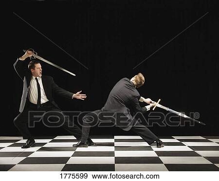 Two businessmen in a sword fight View Large Photo Image Stock Photo - Two businessmen in a sword fight. Fotosearch