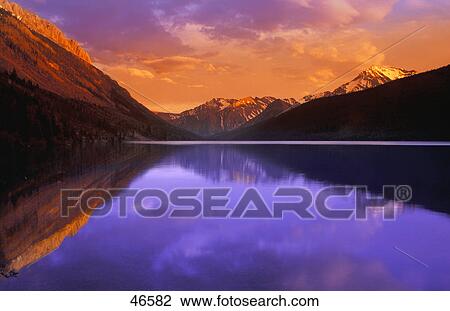 Calm lake with mountain behind View Large Photo Image Stock Image - Calm lake with mountain behind. Fotosearch