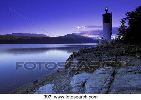 Lighthouse and lake at dawn View Large Photo Image Stock Photo - Lighthouse and lake at dawn. Fotosearch
