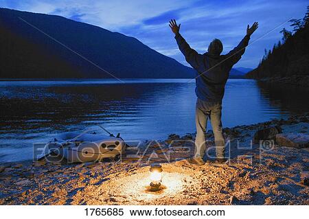 Man lifts his hands towards the heavens View Large Photo Image Stock Photography - Man lifts his hands towards the heavens. Fotosearch