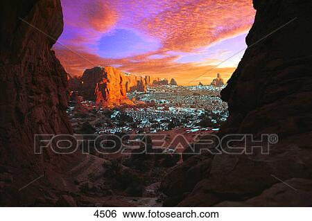 Stock Photograph - Rocky buttes viewed through canyon. Fotosearch
