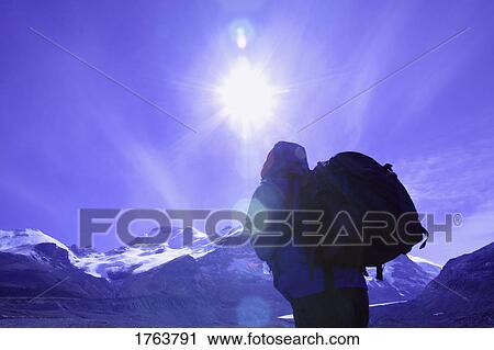 Stock Image - Tourist going for a hike Columbia Ice fields Jasper National Park Alberta. Fotosearch