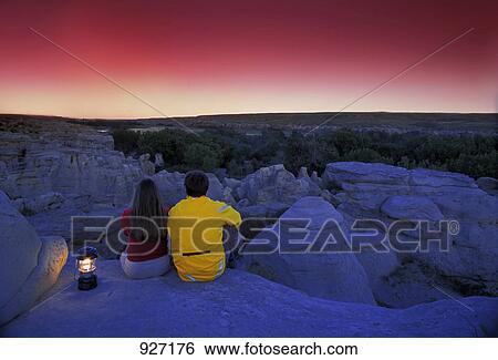 Stock Photograph - Couple enjoys sunrise/sunset. Fotosearch