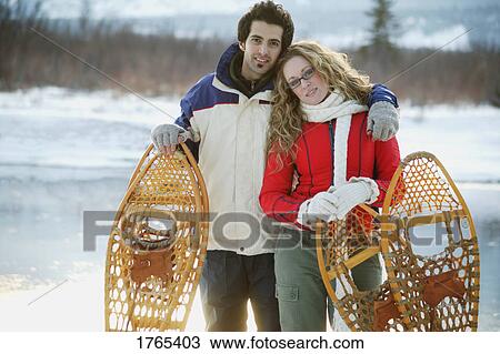 Couple with snowshoes View Large Photo Image Stock Image - Couple with snowshoes. Fotosearch