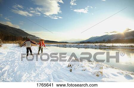 Stock Image - Couple with snowshoes. Fotosearch
