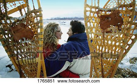 Stock Image - Couple with snowshoes. Fotosearch
