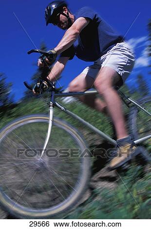 Stock Photograph - Cyclist going downhill. Fotosearch