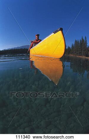 Man in yellow canoe on lake View Large Photo Image Stock Image - Man in yellow canoe on lake. Fotosearch