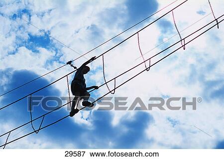 Silhouette of person crossing Burmese bridge View Large Photo Image Stock Photo - Silhouette of person crossing Burmese bridge. Fotosearch
