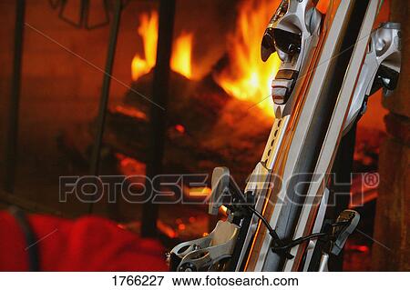 Stock Photo - Skis beside a fireplace. Fotosearch