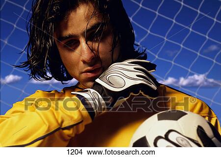 Soccer goalkeeper in net View Large Photo Image Picture - Soccer goalkeeper in net. Fotosearch