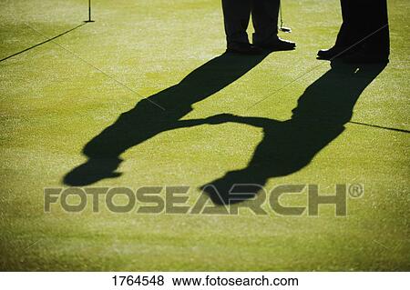Two golfers shake hands View Large Photo Image Stock Photo - Two golfers shake hands. Fotosearch