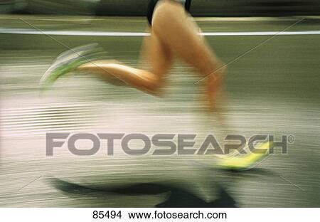 Picture - Blurred image of runner on road. Fotosearch