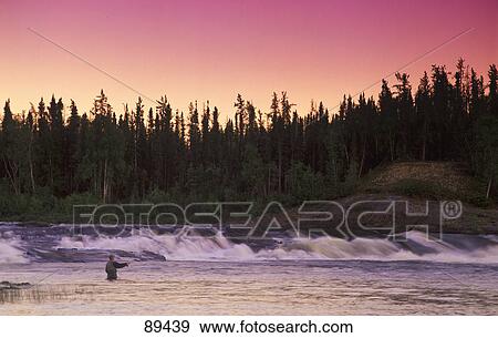 Stock Photo - Man fly-fishing in river. Fotosearch