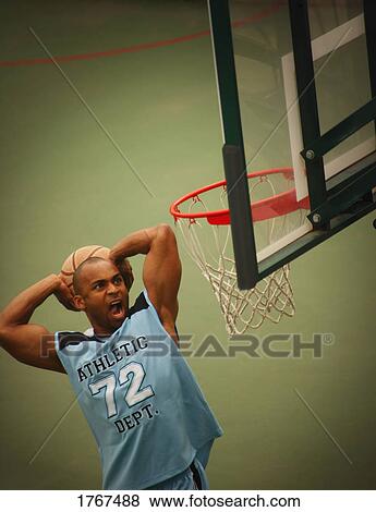 Stock Photo - Man playing basketball. Fotosearch