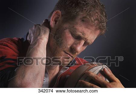 Picture - Rugby player holding ball. Fotosearch