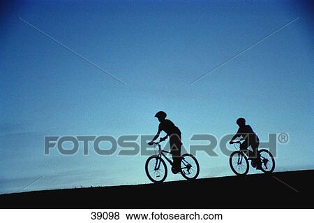 Silhouette of cyclists on hill View Large Photo Image Stock Photo - Silhouette of cyclists on hill. Fotosearch