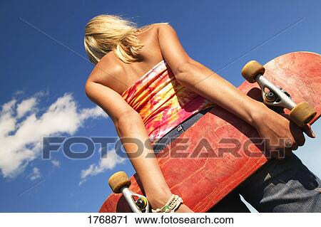 Stock Image - A teenager with a skateboard. Fotosearch