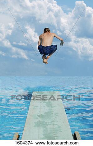Boy jumps into water View Large Photo Image Picture - Boy jumps into water. Fotosearch