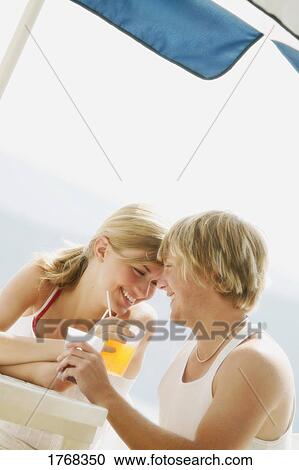 Couple enjoys a beverage View Large Photo Image Stock Image - Couple enjoys a beverage. Fotosearch